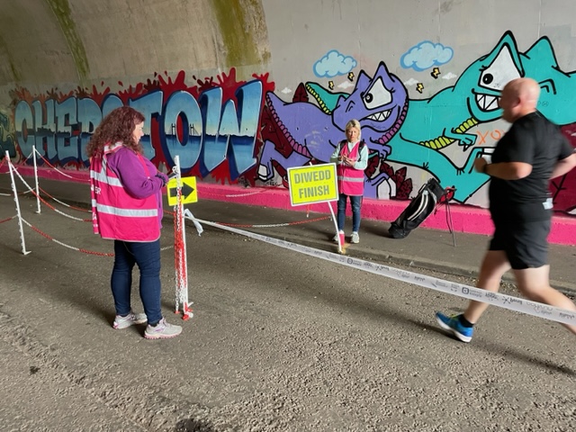 Parkrun Severn Bridge - runners and volunteers, graffiti on walls in background